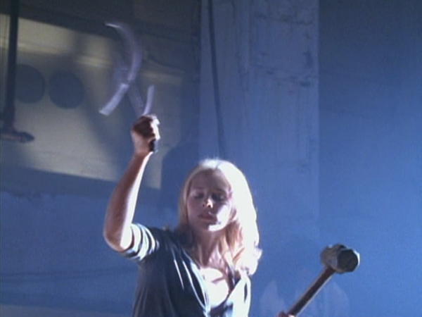 Buffy wielding a hammer and sickle-like weapon