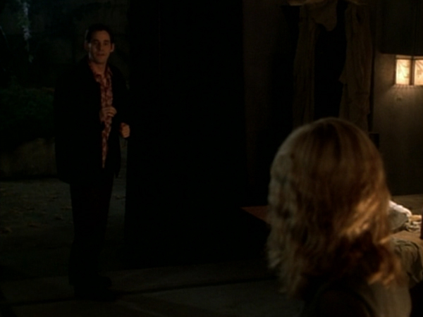 Xander stands nervously to one side of Buffy and Angel.